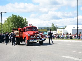 A procession for the late firefighter Larry Lopes marches down Dahl Dr. on June 22. Lopes served as captain of fire prevention for over three decades (Peter Shokeir | Whitecourt Star).