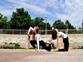 Dancers Abbey Richens (left) and Ashlyn Carwana, members of Sound in Motion Studio, add a human element to graphics in Ivey Park. The pair will be part of the London Dance Festival’s Emerging Artists Showcase this Sunday. (CHRIS MONTANINI\LONDONER\POSTMEDIA NETWORK)