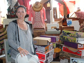 Danielle Sutton owner of I Want That Bag stands among piles
of damaged goods due to water. (Ryan Berry/Kincardine News and Lucknow Sentinel)