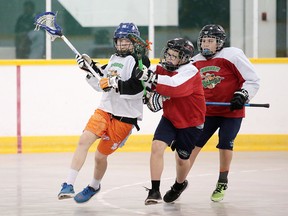 Brandon Roney of Stealth and Cain Savage of the Roughnecks battle during Greater Sudbury Lacrosse peewee championship game action in Sudbury, Ont. on Sunday June 25, 2017. Gino Donato/Sudbury Star/Postmedia Network