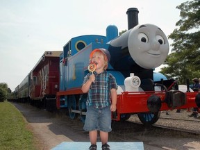 Marshall Schwartz, 3, of Kitchener, enjoys a lollypop in front of Thomas the Tank Engine during the iconic blue steamer’s visit to St. Thomas in 2015. (File photo)