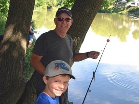 Grandpa and grandson Dave Taylor, back, and Sam Taylor reel ‘em in during the ninth annual St. Thomas Fishing Derby at Pinafore Park pond last year. The 2017 catch-and-release fishing fete will be held July 7. (File/Jennifer Bieman/Times-Journal)