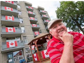 Henry McCambridge has led the effort at his Vanier apartment building at 280 Montfort to cover as many balconies and common areas with as many Canadian flags as possible. (Wayne Cuddington, Postmedia)