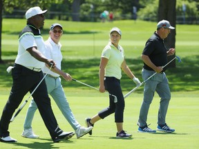 Former NFL star Bo Jackson, John Veihmeyer, chairman of KPMG, Canada’s Brooke Henderson and former MLB pitcher Greg Maddux stroll up a fairway during the pro-am at the 2017 KPMG Women’s PGA Championship in Olympia Fields, Ill., on June 27, 2017. (Getty Images)