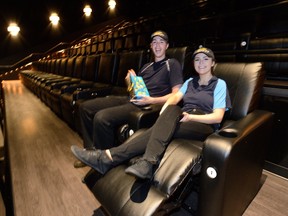 Employees Holly Gunn and Dallas Elliott demonstrate the new recliner chairs at the Westmount movie theatres Tuesday. Cineplex is in the process of putting the bigger, reclining seats in its theatres at Silver City and Westmount, as well as 13 ohers across Canada.  (MORRIS LAMONT/THE LONDON FREE PRESS)
