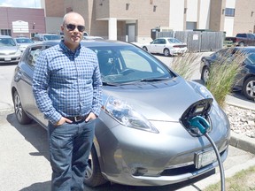 Sean Hart stands beside his Nissan Leaf, a fully electric car he uses to commute between Chatham and his home in Belle River. The charging station, located at the downtown Tim Hortons, is the latest in the rapidly growing electric vehicle infrastructure around Southwestern Ontario.