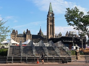 Temporary stairs are installed over the fence in front of Parliament Hill, in preparation of the upcoming Canada Day celebrations, in Ottawa on Wednesday, June 28, 2017. THE CANADIAN PRESS/Fred Chartrand