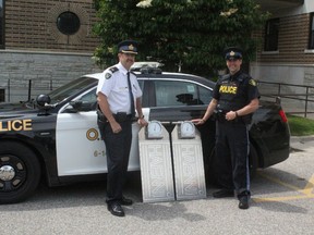 Elgin OPP detatchment commander Inspector Brad Fishleigh, left, and Constable Adam Crewdson stand beside the two portable weight scales, which were purchased by the Police Services Board. The scales will help ensure trucks on the road don’t exceed their allowed weight. (Laura Broadley/Times-Journal)