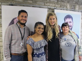 From left, Roger Romero Jr., Sonal Gupta, Claire Bouvier and Jackie Jobin gather at City Hall on Tuesday to celebrate the unveiling of Bouvier’s photography project, called “Meet Your Neighbour,” which introduces Kingston residents from different cultural backgrounds. (Ashley Rhamey/For The Whig-Standard)