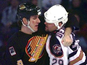 Troy Crowder, left, tangles with Louie Debrusk during an NHL game in 1996. Crowder will be acclaimed on June 29 to run for the Progressive Conservatives in the 2018 provincial election. Photo by Shaughn Butts/Postmedia Network