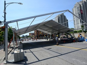A large tent is being set up on Talbot Street in front of Budweiser Gardens, one of many being assembled in the downtown to prepare for Canada 150 celebrations on Saturday. (MORRIS LAMONT/THE LONDON FREE PRESS)
