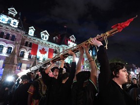 People hold a teepee, intended to be erected on Parliament Hill as part of a four-day Canada Day protest during a demonstration in Ottawa on Thursday, June 29, 2017.