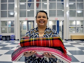 Jacqueline Fraser, lead co-ordinator of Northeast Community Conversations, holds a couple of the blankets used in a recent KAIROS Blanket Exercise, an interactive workshop about the history of indigenous peoples in Canada. (CHRIS MONTANINI\LONDONER\POSTMEDIA NETWORK)