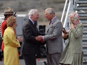 Governor General David Johnston (centre, left) and Sharon Johnston (left) greet Prince Charles and Camilla, Duchess of Cornwall (right) as they arrive at the airport in Iqaluit, Nunavut Thursday June 29, 2017. THE CANADIAN PRESS/Adrian Wyld