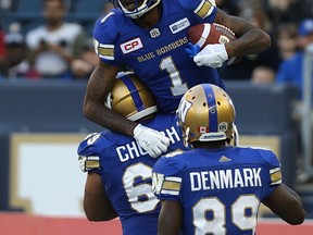 Winnipeg Blue Bombers receiver Darvin Adams is hoisted by Sukh Chungh after his touchdown catch against Edmonton Eskimos during CFL exhibition action in Winnipeg on June 15, 2017. (Kevin King/Winnipeg Sun/Postmedia Network)