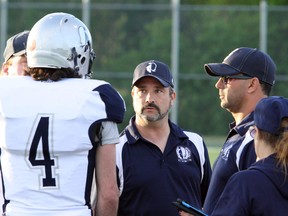 Sudbury Spartans head coach Junior Labrosse, centre, talks with quarterback Jordan Cecchetto and members of his coaching staff during a game against the North Bay Bulldogs at James Jerome Sports Complex in Sudbury on Saturday, June 24, 2017. Ben Leeson/The Sudbury Star/Postmedia Network