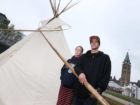 Elsa Hoover and Brendon Nahwegezhic stand next to a teepee on Parliament Hill in Ottawa Ontario Thursday June 29, 2017. A group held a press conference early Thursday morning, saying they wished to draw attention to a number of issues affecting Indigenous Peoples, including the apprehension of children by welfare authorities, murdered and missing indigenous women and racism. Elsa and Brendon wanted it to be clear that they were holding a ceremony, not a protest.