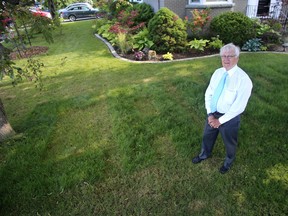 Dr. Ian Gemmill, retiring Kingston, Frontenac, Lennox & Addington Public Heath Medical Officer of Health in his Kingston front yard with 'Canada' and 1867-2017 carved into his grass on Wednesday June 28 2017. Ian MacAlpine /The Whig-Standard/Postmedia Network