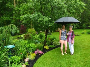 Melinda Wonnacott (left) ramped up her efforts in the garden this spring after learning from Marg O?Reilly (right) and the Stratford and District Horticultural Society?s Garden Tour organizing committee that her property would be featured in the tour on Sunday. (Galen Simmons/Postmedia News)