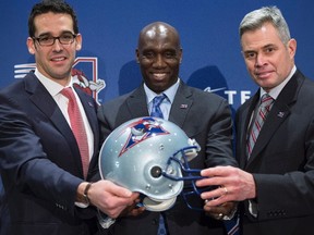 Newly-announced Montreal Alouettes president Patrick Boivin, general manager Kavis Reed and head coach Jacques Chapdelaine, left to right, hold a team helmet at a news conference, Wednesday, December 14, 2016 in Montreal.