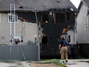 Fire crews clean up after a fire destroyed a duplex at 5615 203 Street on Thursday June 29, 2017, in Edmonton. Greg Southam/Postmedia