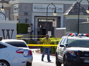 Las Vegas police investigate a shooting at a pain-management clinic in Las Vegas, Thursday, June 29, 2017. A patient denied a same-day appointment at the clinic in Las Vegas shot and injured two employees Thursday before fatally shooting himself, police said. (Richard Brian/Las Vegas Review-Journal via AP)