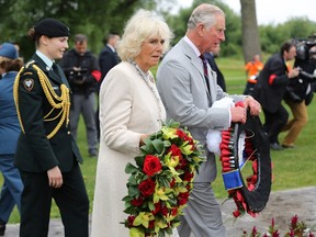 Prince Charles and Camilla Duchess of Cornwall walk with wreaths to be placed at the Afghanistan War Memorial at CFB in Trenton, Ont., on Friday June 30, 2017. THE CANADIAN PRESS/Lars Hagberg