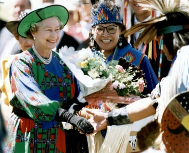 Queen Elizabeth greets onlookers during a walkabout in Calgary in 1990 Natives welcome Queen Elizabeth II to Spruce Meadows in 1990.  (Postmedia Network File Photo)