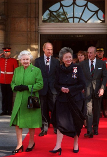 Queen Elizabeth II and Gov.-Gen. Adrienne Clarkson walk out the front door of Rideau Hall for a tree planting ceremony in Ottawa, Oct. 13, 2002. The Queen attended a ceremony as part of her last stop on the golden jubilee tour of Canada.