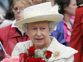 Queen Elizabeth II carries flowers as she does a walkabout of Sir Winston Churchill Square after touring City Hall in Edmonton, Alta., Wednesday May 25, 2005.