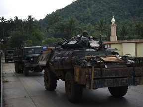 Philippine troops from the frontline drive past a mosque aboard their armoured personnel carrier this week on the outskirts of Marawi on the southern island of Mindanao where Islamist militants are occupying parts of a southern Philippine city. (TED ALJIBE/AFP Photo)