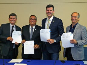 (Left to Right) Tom Ruth (President and CEO of Edmonton International Airport), City of Leduc Mayor Greg Krischke, City of Edmonton Mayor Don Iveson and Leduc County Mayor John Whaley hold the signed annexation agreement on June 30, 2017 at Edmonton International Airport between the City of Edmonton and Leduc County. Larry Wong/Postmedia