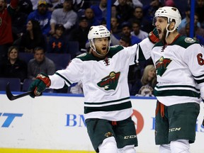 In this April 24, 2015, file photo, Minnesota Wild's Jason Pominville, left, congratulates teammate Marco Scandella after he scored during the first period in Game 5 of an NHL hockey first-round playoff series against the St. Louis Blues, in St. Louis. Former Sabres captain Jason Pominville is returning to Buffalo after being acquired along with defenseman Marco Scandella in a four-player trade with the Minnesota Wild, Friday, June 30, 2017. (AP Photo/Jeff Roberson, File)