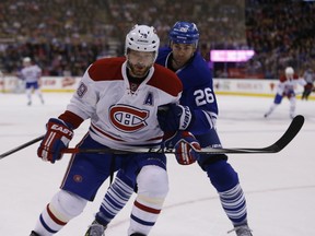 Toronto Maple Leafs Daniel Winnik (26) takes Montreal Canadiens Andrei Markov (79) to the boards during the first period in Toronto on Saturday January 23, 2016. (Jack Boland/Postmedia Network)