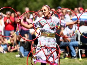 Sandra Larouche from Big Stone Cree performs a hoop dance during the First Nations PowWow for Canada Day 2015 featuring 6 drumming groups from Calgary and surrounding areas at Princess Island Park during Canada Day celebrations in Calgary on Wednesday July 1, 2015. Darren Makowichuk/Postmedia