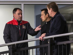 Ottawa Senators General manager Pierre Dorion (L) speaks with head coach Guy Boucher and assistant general manager Randy Lee (R) while watching the 2016-17 Ottawa Senators rookie camp. Thursday September 15, 2016. (Errol McGihon/Postmedia Network)