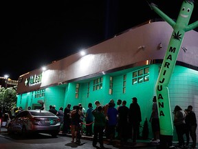 People line up at the NuLeaf marijuana dispensary, Saturday, July 1, 2017, in Las Vegas. Nevada dispensaries were legally allowed to sell recreational marijuana starting at 12:01 a.m. Saturday. (AP Photo/John Locher)