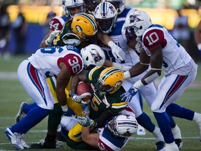 Edmonton Eskimos Travon Van (5) is tackled by the Montreal Alouettes during first half CFL action on Friday June 30, 2017, in Edmonton.