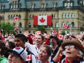 People take in the Canada 150 celebrations on Parliament Hill in Ottawa on Saturday, July 1, 2017. THE CANADIAN PRESS/ Sean Kilpatrick