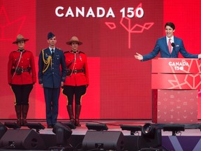 Canadian Prime Minister Justin Trudeau addresses the crowd as people celebrate Canada's 150th birthday on Parliament Hill in Ottawa on July 1, 2017. Britain's Prince Charles and his wife Camilla are visiting to celebrate the 150th anniversary of Canada's founding. CHRIS ROUSSAKIS/AFP/Getty Images