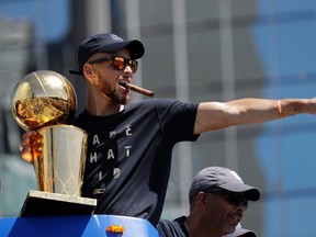In this June 15, 2017, file photo, Golden State Warriors' Stephen Curry gestures while holding the Larry O'Brien trophy during a parade and rally after winning the NBA basketball championship, in Oakland, Calif. Two-time NBA MVP Stephen Curry is set to test his golf game against the pros. The Web.com Tour announced Wednesday, June 28, 2017, that Curry, who recently won his second NBA championship with the Golden State Warriors, will play in the Ellie Mae Classic. The event at TPC Stonebrae runs from Aug. 3-6. (AP Photo/Marcio Jose Sanchez, File)