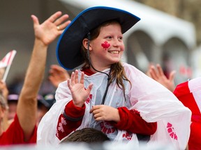 A young woman displays national pride during the early part of Canada Day celebrations at Parliament Hill on Saturday.
