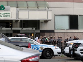 Police gather outside Bronx Lebanon Hospital in New York after a gunman opened fire and then took his own life there on Friday, June 30, 2017. The gunman, identified as Dr. Henry Bello who used to work at the hospital, returned with a rifle hidden under his white lab coat, law enforcement officials said. (AP Photo/Mary Altaffer)