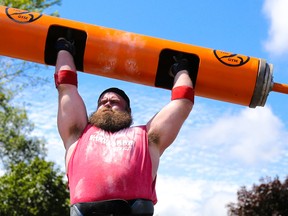 Padraic Moore of Wellington competes in the log press event during Vanderlaan Building Products Ontario's Strongest Man 2017 competition in Centennial Park on  Saturday July 1, 2017 in Quinte West, Ont. The event was held in conjunction with Canada Day festivities in the park. Tim Miller/Belleville Intelligencer/Postmedia Network