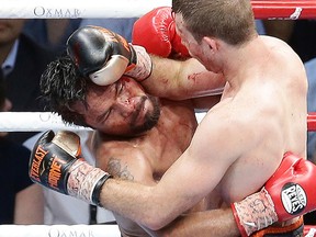 Manny Pacquiao of the Philippines, left, clinches with Jeff Horn of Australia, during their WBO World Welterweight title fight in Brisbane, Australia, Sunday, July 2, 2017. (AP Photo/Tertius Pickard)