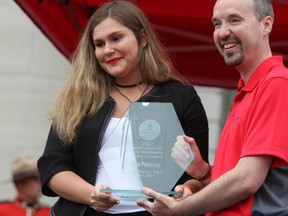 Kingston Mayor Bryan Paterson presents Erin Peterson with the Mayor's Award for Youth Volunteerism at the civic ceremony in front of city hall on Canada Day. (Steph Crosier/The Whig-Standard)