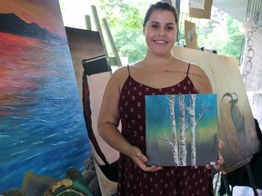 Kingston artist Sierra Da Silva at the First Nations Pavilion at Artfest in City Park on Canada Day. (Steph Crosier/The Whig-Standard)