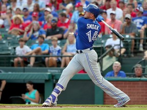 Justin Smoak #14 of the Toronto Blue Jays hits an RBI single against the Texas Rangers in the top of the first inning at Globe Life Park in Arlington on June 21, 2017 in Arlington, Texas. (Tom Pennington/Getty Images)