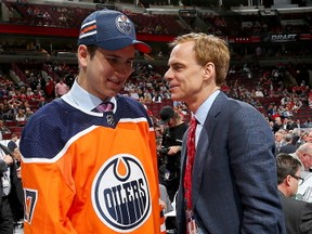 Kirill Maksimov meets with executive Scott Howson after being selected 146th overall by the Edmonton Oilers during the 2017 NHL Draft at the United Center on June 24, 2017 in Chicago, Illinois.