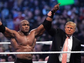 In this Sunday, April 1, 2007, file photo, Donald Trump raises the arm of wrestler Bobby Lashley after he defeated Umaga at Wrestlemania 23 at Ford Field in Detroit. Trump body-slammed and then shaved the head of WWE boss Vince McMahon after what was known as the “Battle of the Billionaires." Wrestling aficionados say the president has, consciously or not, long borrowed the time-tested tactics of the game to cultivate the ultimate antihero character, a figure who wins at all costs, incites outrage and follows nobody’s rules but his own. (AP Photo/Carlos Osorio, File)